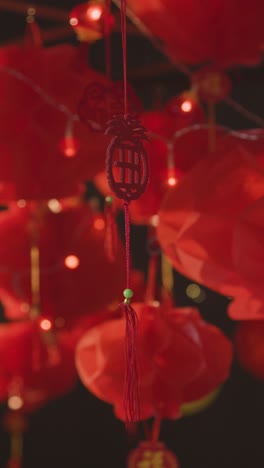 Vertical-Video-Close-Up-Of-Chinese-Symbol-Hanging-From-New-Year-Lantern